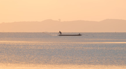 Fisherman working at the Songkhla lake in beautiful morning light. 