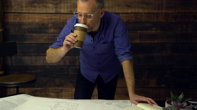 Architect drinking coffee marks on prints