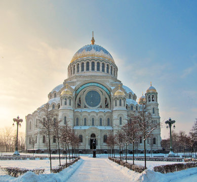 Kronstadt Naval Cathedral (Marine Cathedral) near the St. Petersburg, Russia.
Winter day skyline with building, street lights, trees against sky with sunlight.