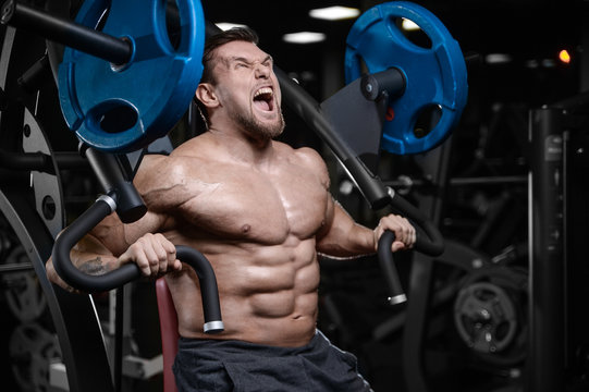 Brutal strong bodybuilder athletic men pumping up muscles with dumbbells.