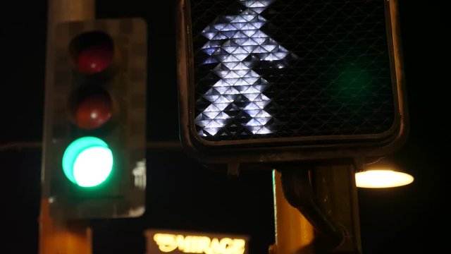 A crosswalk signal illuminated at night