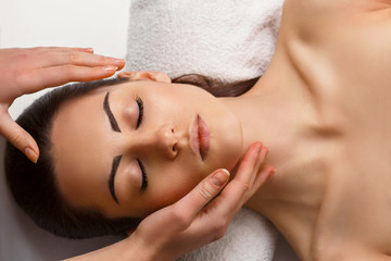 Fototapeta na wymiar Face Massage. Close-up of a Young Female Getting Spa Treatment...Woman Skin Care.Body care