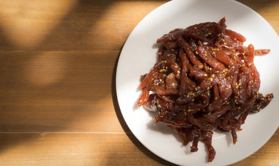 top view of sweet dried pork on wooden background