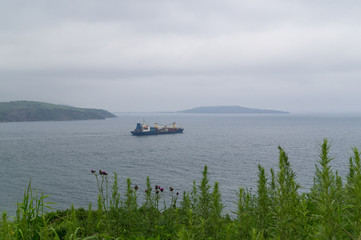 A merchant ship leaves its home port.