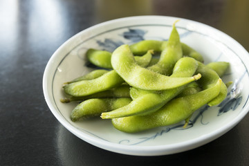 boiled green soy beans or edamame on plate