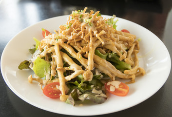 Fried shimeji mushroom salad on white plate