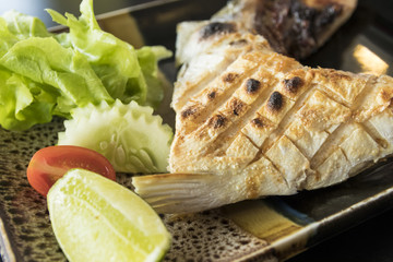 Grilled hamachi kama fish on plate - japanese food
