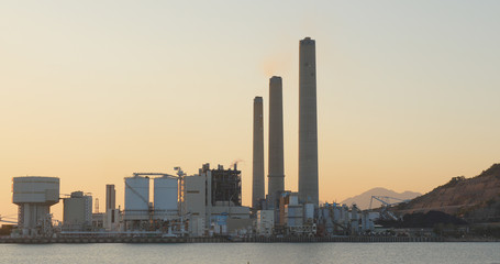 Power station under sunset