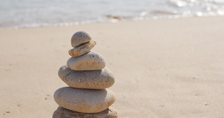 Fototapeta na wymiar Zen stones on a sand beach