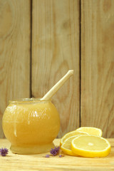 Vertical still life, a barrel of honey and lemon, as a remedy for colds