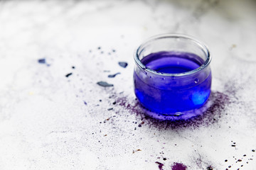 Tin with water painted violet. Artist workplace concept.