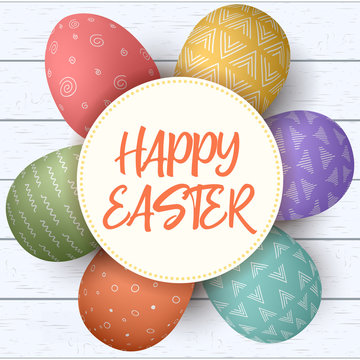 Happy Easter. Festive easter eggs in circle on shabby wooden background. colorful eggs with rustic ornaments.