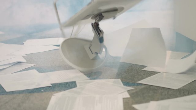 Something smoking in modern office. Documents throwing on floor. Monitor falling to floor. Smoke spreading everywhere. Indoors.