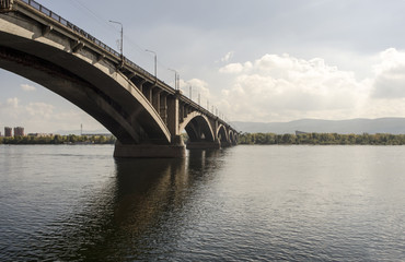 Fototapeta na wymiar Bridge over river. Siberian city