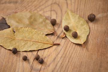 Dried bay laurel leaves and peppercorns