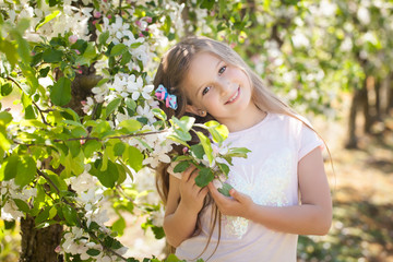 Beautiful young girl in spring garden