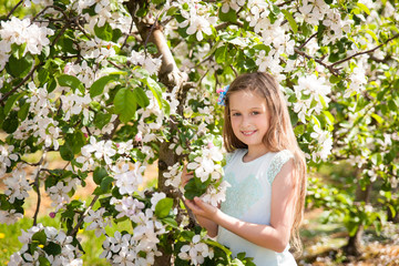 Beautiful young girl in spring garden