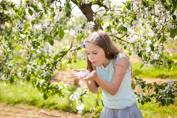 Beautiful young girl in spring garden