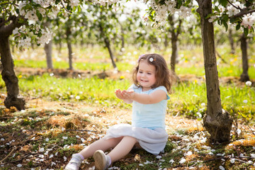 Beautiful young girl in spring garden