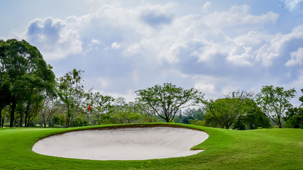 The sand bungker in golf course with blue cloud sky background