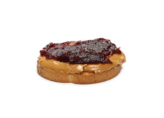 Bread slice with peanut butter and cherry marmalade, jelly isolated on white background
