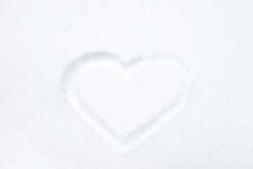 Heart shape drawing on white snow as love valentine background