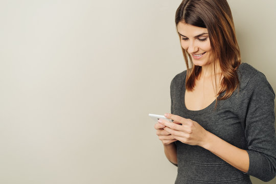 Smiling woman reading her text messages