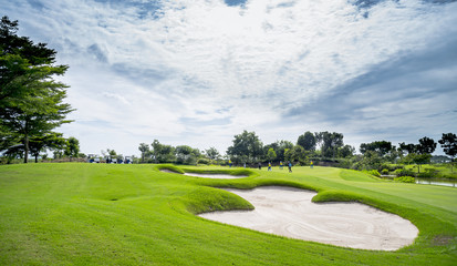 The sand bungker in golf course with blue cloud sky background