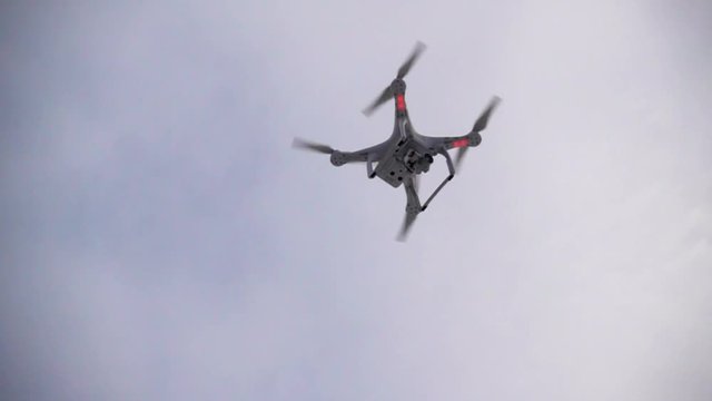 Drone flying in the sky. Flight and rotation of propellers in slow motion.