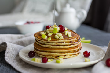 Pancakes with apple, berries and honey. Concept health breakfast.