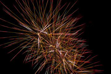 Brightly colorful fireworks a variety of colors in the sky at night