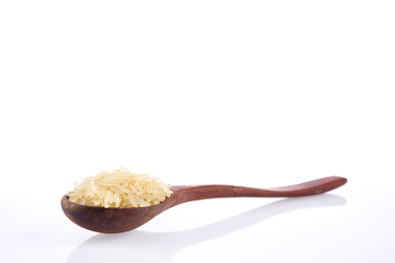 Shallow depth of field close-up photo of raw jasmine rice in wooden spoon isolated on white background