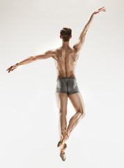 The male athletic ballet dancer performing dance isolated on white background. - obrazy, fototapety, plakaty