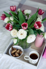 Romantic breakfast in bed. Bouquet of flowers. Roses and tulips. Spring. Valentine's Day. International Women's Day. Cozy.