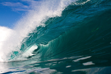 Beautiful perfect wave crashing on a shallow coral reef in indonesia