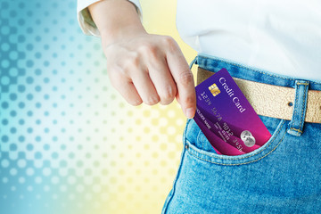 women hand pick up realistic credit or debit card on graphic background for copy space