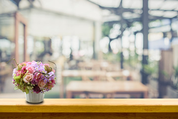 beautiful flower vase on wood table in chill out restaurant for idea concept
