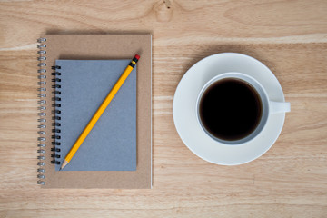 coffee and book on wood table