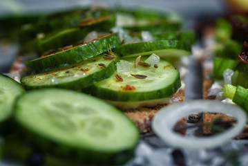 Toast with cucumber slices, cream cheese, coarse bread and spices.