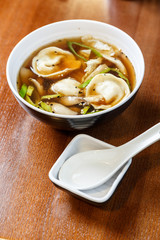 Asian dumplings served and prepared as a soup