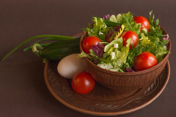 Salad with cherry tomatoes, arugula, iceberg, cabbage, cucumber, egg - delicious dinner