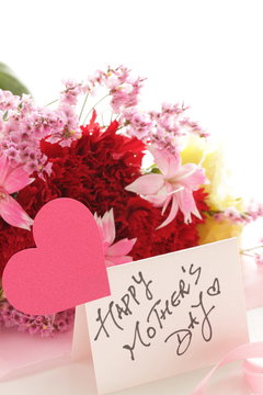 hanrd written Mother's day card and carnation bouquet