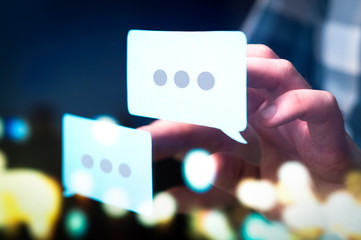 Communication, dialog, conversation on an online forum and internet chatting concept. Business man or social media consultant holding speech bubbles in futuristic modern abstract space. - obrazy, fototapety, plakaty
