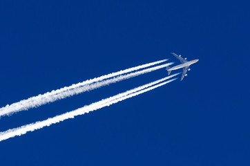 Airplane big four engines aviation airport contrail clouds.