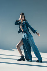 beautiful young woman in trendy denim clothes posing for fashion shoot