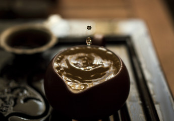 Pouring of Exquisite Green Tea from Teapot at Traditional Chinese Tea Ceremony. Set of Equipment for Drinking Tea