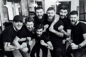 Professional hairstylists in barbershop interior