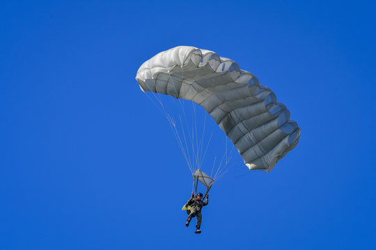 Skydriver jumping with parachut with blue cloud sky background