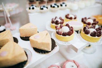 Pink candy bar. Luxury cakes on wedding dessert table in restaurant. 
