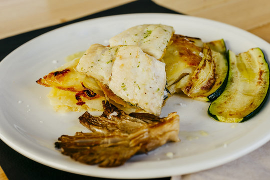 Hake with stewed potato and mushrooms